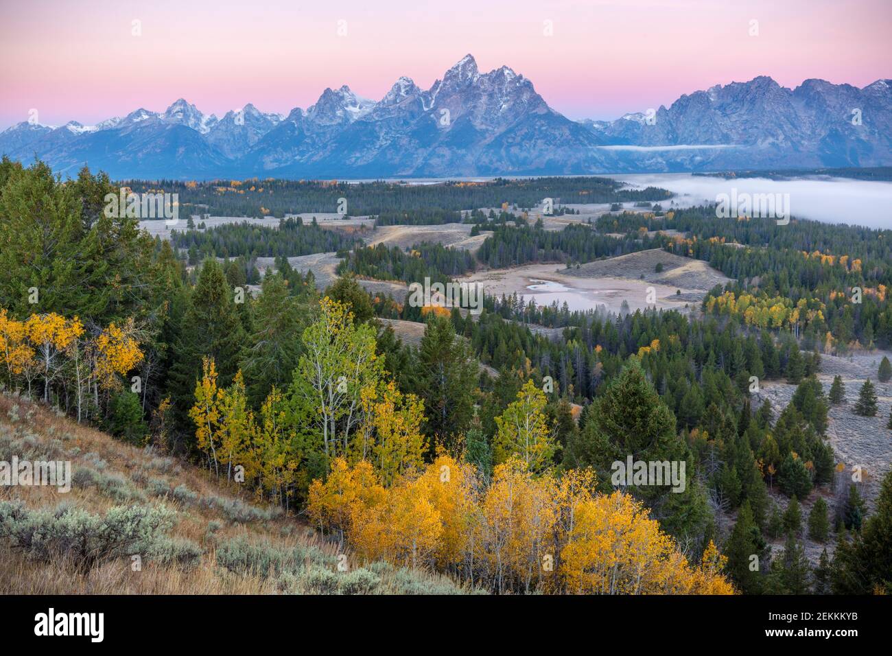 Grand Teton National Park, WY: Dawn light on the Teton Range with fog in the Snake River Valley Stock Photo