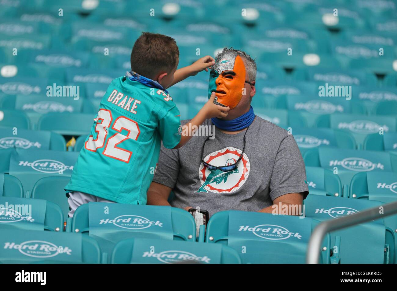 Miami Dolphins fan Jacob 6, adjusts his dad Michael Borg's themed face mask, as the Miami Dolphins host the Buffalo Bills on Sunday, September 20, 2020 at Hard Stadium in