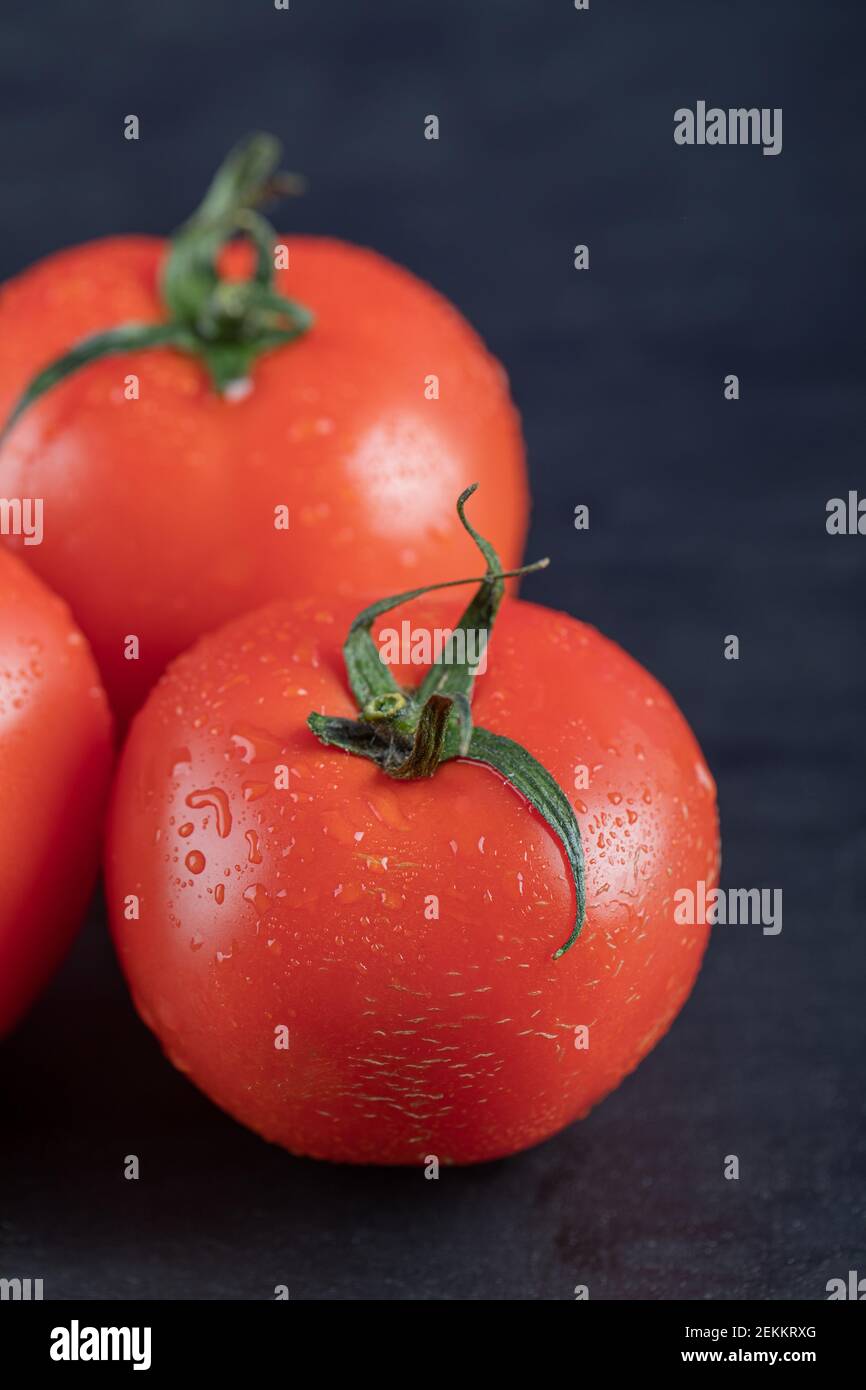 Red fresh tomatoes on a dark background Stock Photo