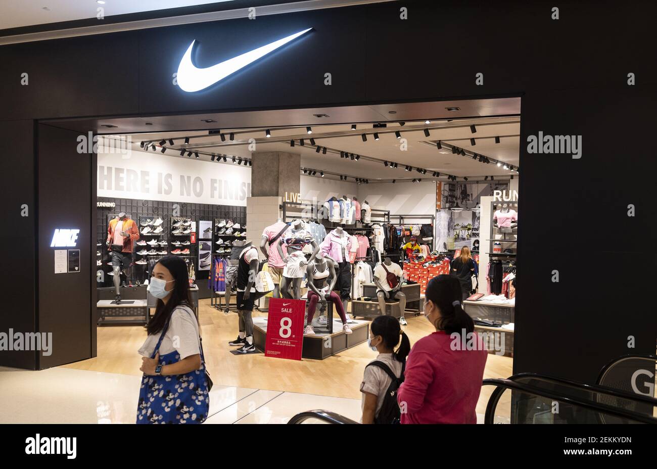 Shoppers wearing face masks walk past American multinational sport clothing  brand Nike store and its logo seen in Hong Kong. (Photo by Budrul Chukrut /  SOPA Images/Sipa USA Stock Photo - Alamy