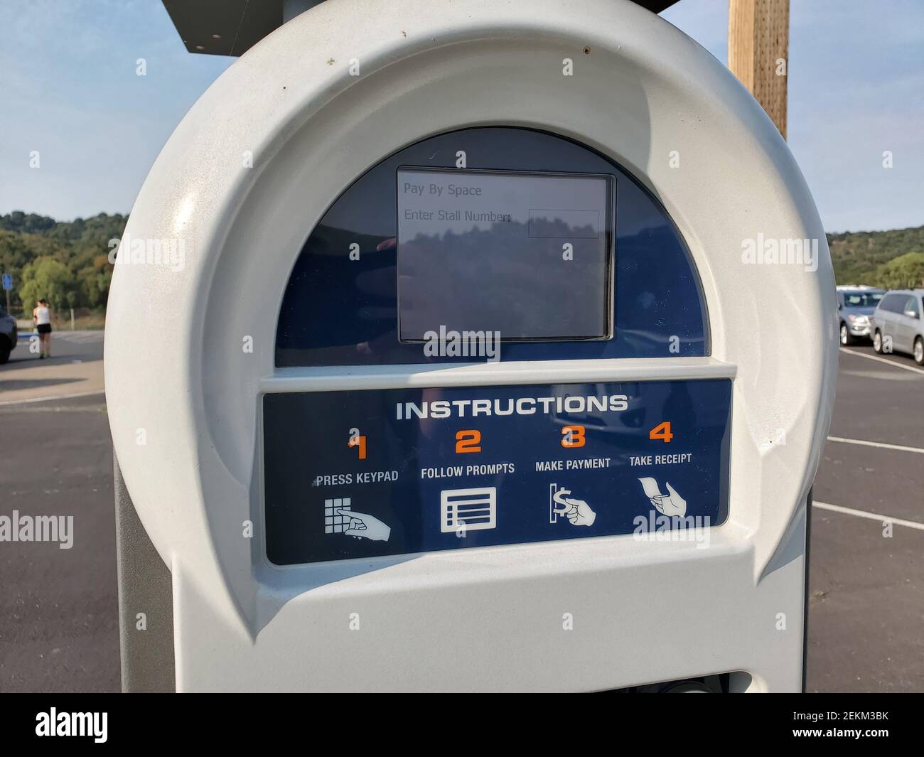 Automated parking kiosk with keypad, screen and solar panel in park