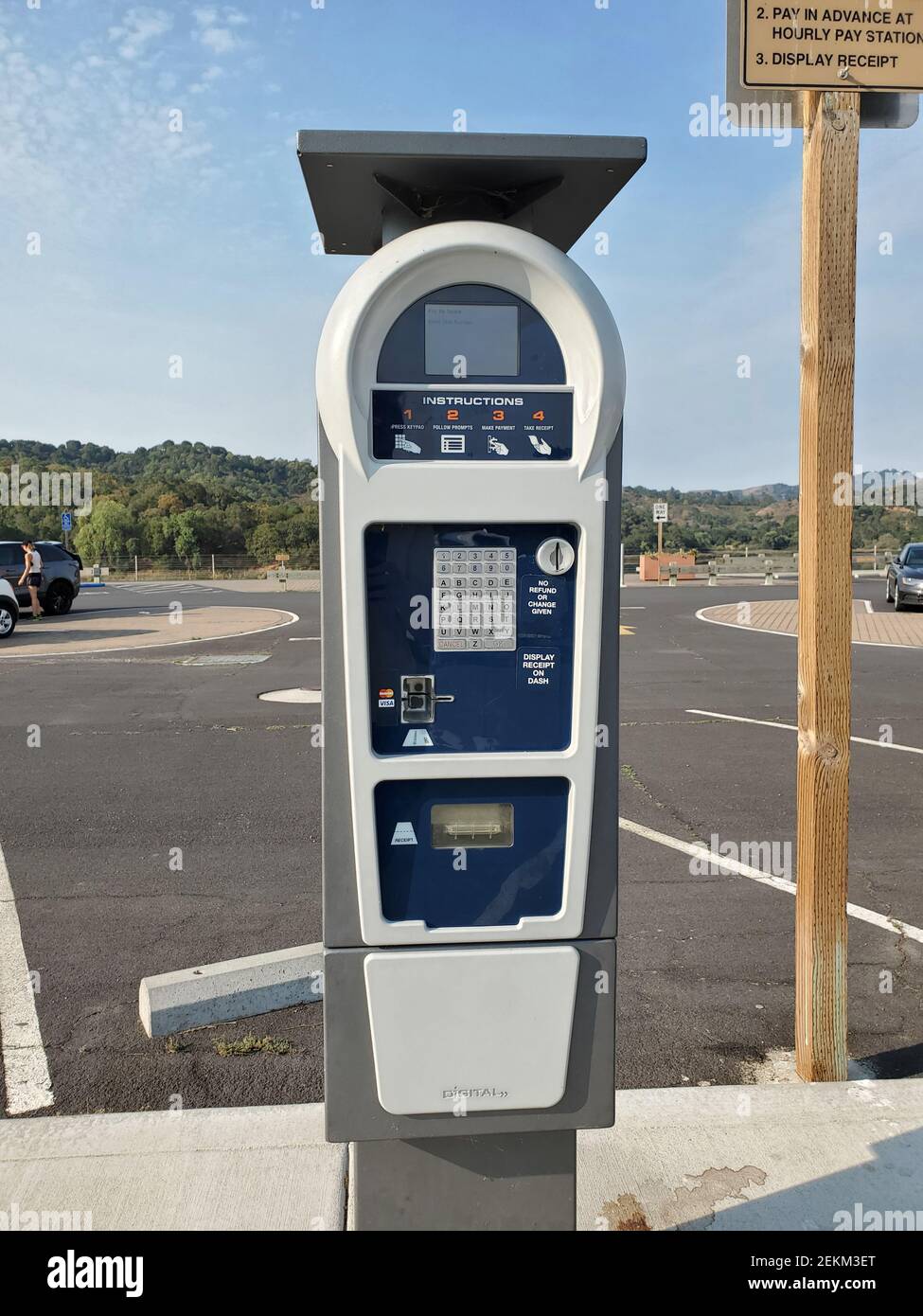 Automated parking kiosk with keypad, screen and solar panel in park
