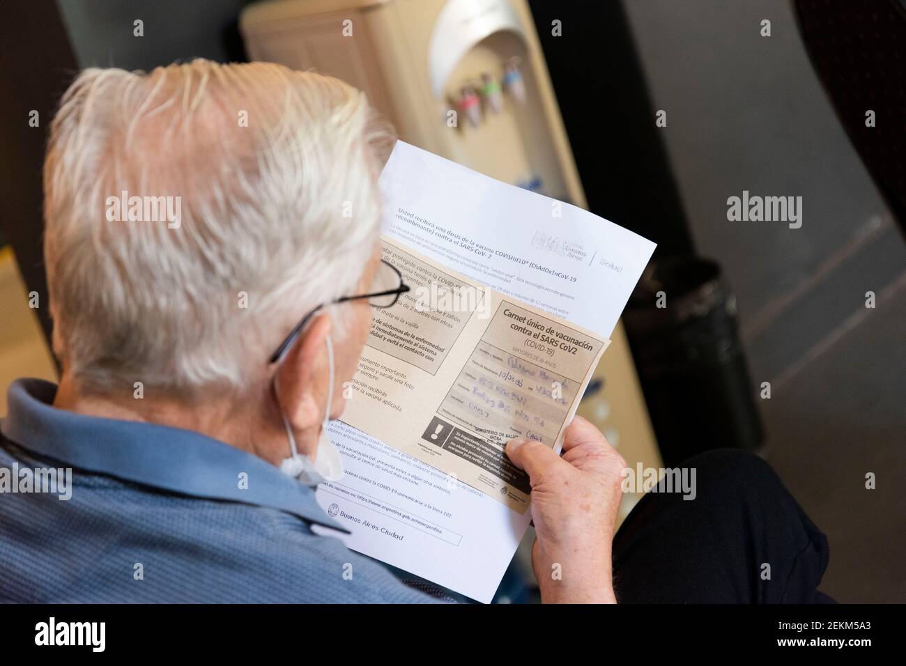 City of Buenos Aires, City of Buenos Aires, Argentina. 23rd Feb, 2021. INT. WorldNews. COVID-19. February 23, 2021. City of Buenos Aires, Argentina.- An old man reads his vaccine certificate for SARS CoV2 (COVID-19) on Feb 23, 2021, at a temporary Vaccination Center at Centro Cultural Recoleta, City of Buenos Aires, Argentina. Adults over 80 years old are being vaccinated for SARS CoV2 (COVID-19) since Feb 22, 2021 in City of Buenos Aires, Argentina. Credit: Julieta Ferrario/ZUMA Wire/Alamy Live News Stock Photo