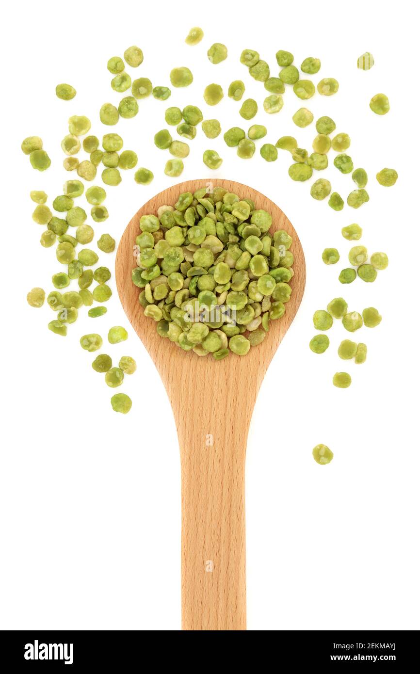 High protein roasted green peas health food in a wooden spoon on white