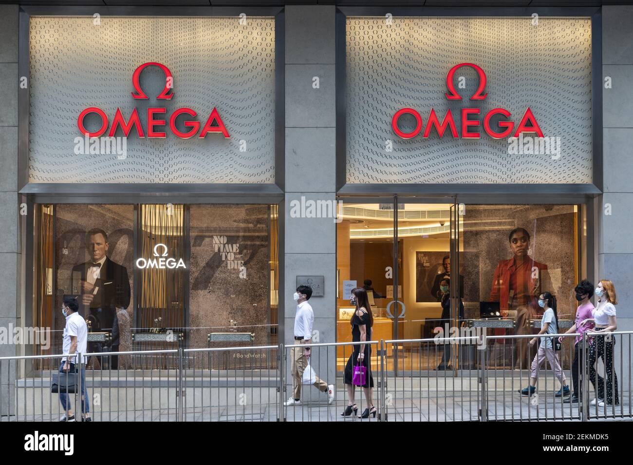 Pedestrians are seen walking past Swiss luxury watchmaker Omega store ...