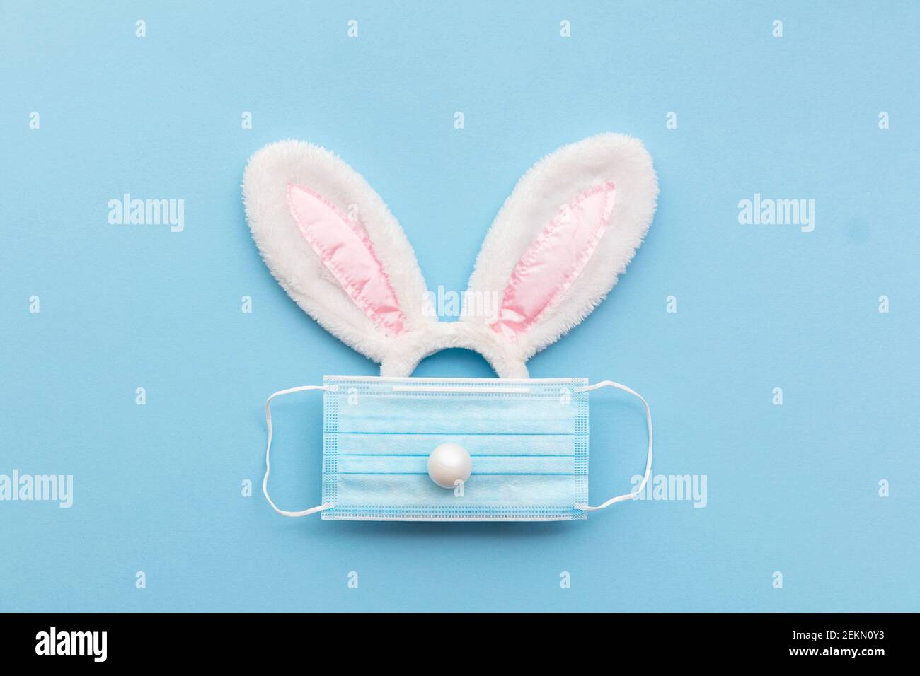 Coronavirus Easter bunny face made from rabbit ears and a protective face mask Stock Photo