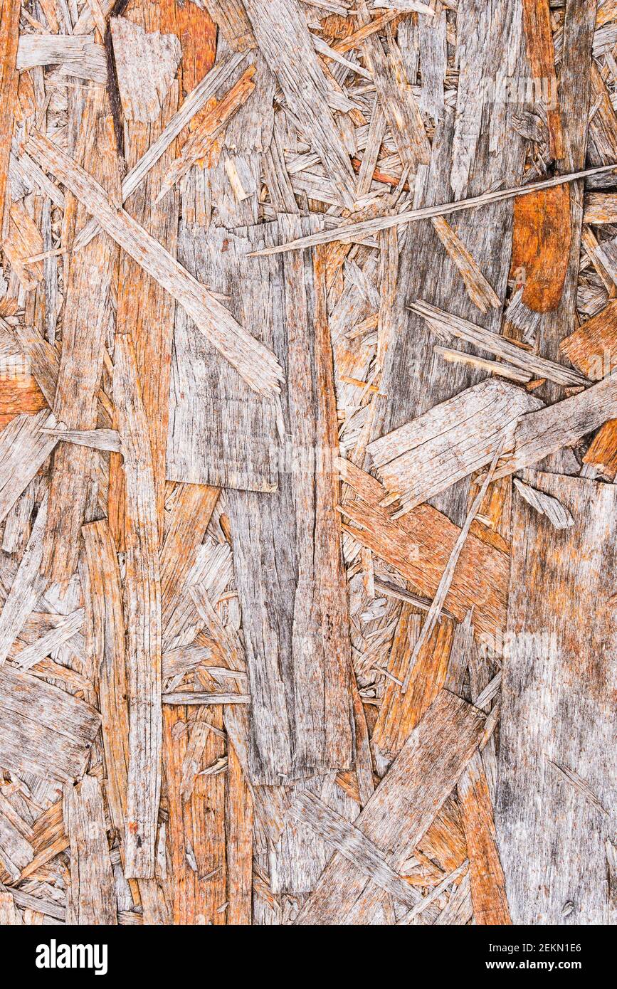 Recycled compressed wood chippings board background. Texture of wooden