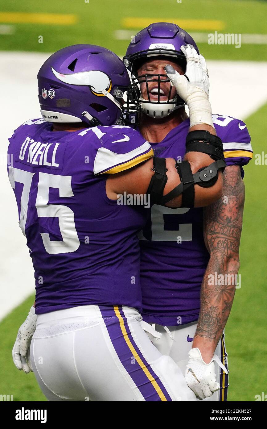 Minnesota Vikings offensive tackle Brian O'Neill (75) greets Dallas Cowboys  defensive end DeMarcus Lawrence (90) on the field after Dallas beat Minnesota  40-3 during an NFL football game Sunday, Nov. 20, 2022