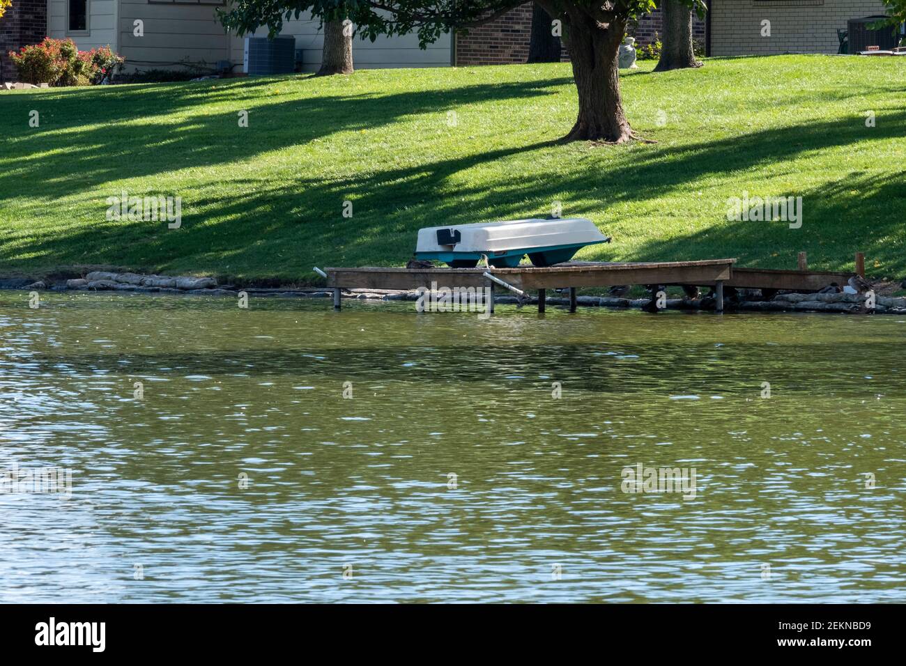 Private access lake off the back yards of homes. Docks, boats. Wichita, Kansas, USA Stock Photo