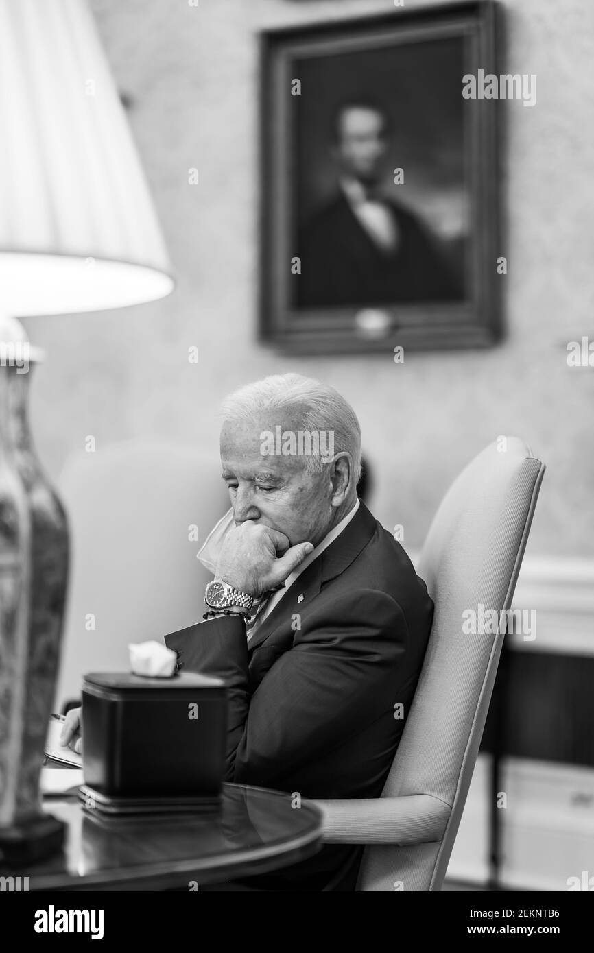 President Joe Biden listens during a weekly personnel meeting Thursday, Feb. 4, 2021, in the Oval Office of the White House. (Official White House Photo by Adam Schultz) Stock Photo