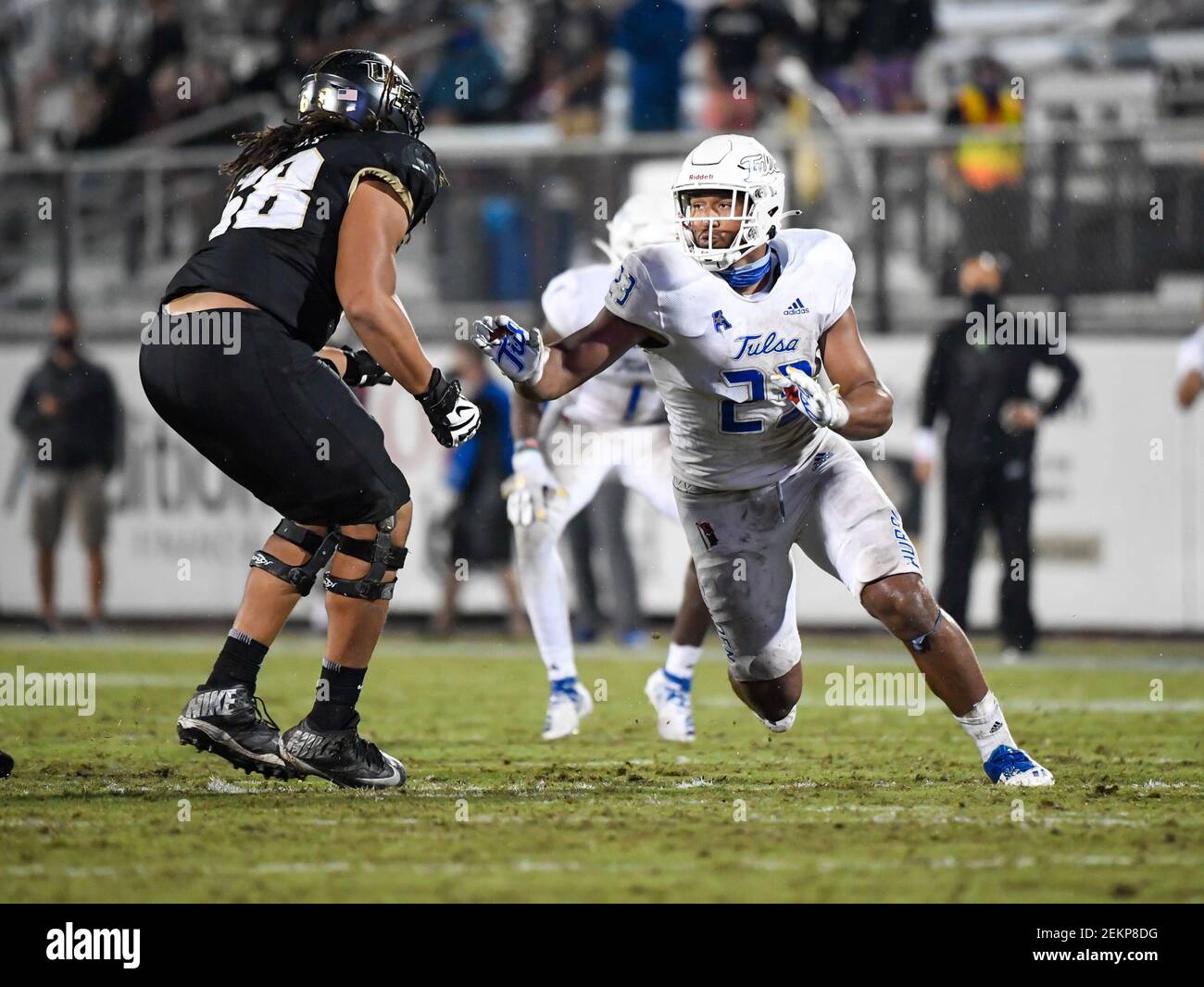 October 3, 2020 - Orlando, FL, U.S: UCF Knights offensive lineman Marcus Tatum (68) attempts to blocks the rush of Tulsa Golden Hurricane linebacker Zaven Collins (23) during 2nd half NCAA football game between the Tulsa Golden Hurricane and the UCF Knights. Tulsa defeated UCF 34-26 at the Bounce House in Orlando, Fl. Romeo T Guzman/Cal Sport Media/Sipa USA(Photo by Romeo Guzman/CSM/Sipa USA) Stock Photo