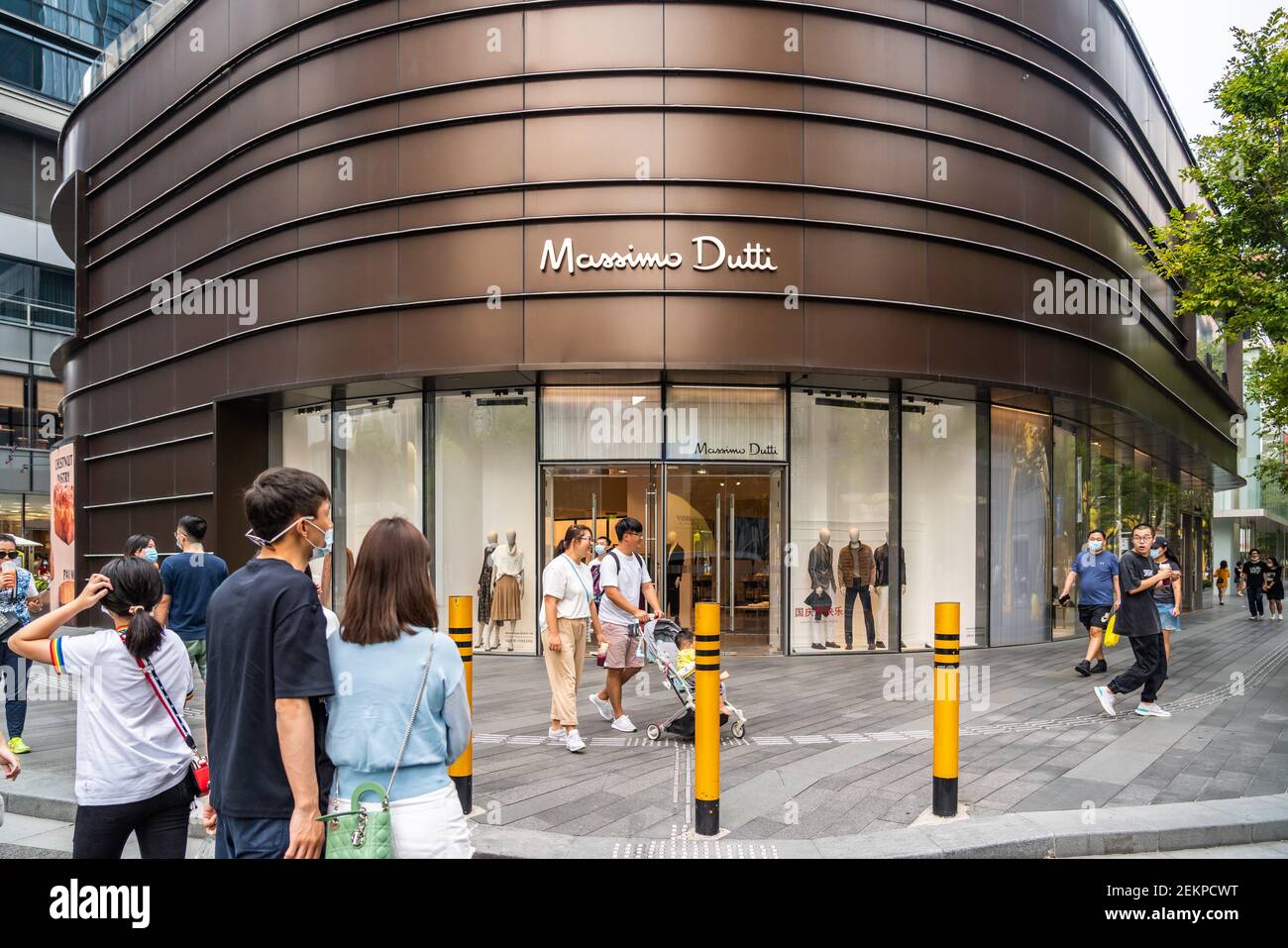 Pedestrians walk past a Massimo Dutti store in Shenzhen. (Photo by Alex Tai  / SOPA Images/Sipa USA Stock Photo - Alamy
