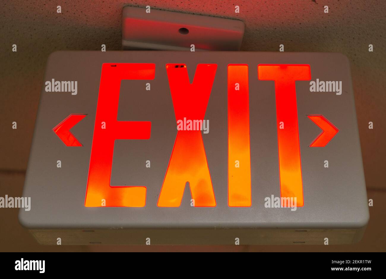 A sign on a ceiling says "EXIT." Stock Photo
