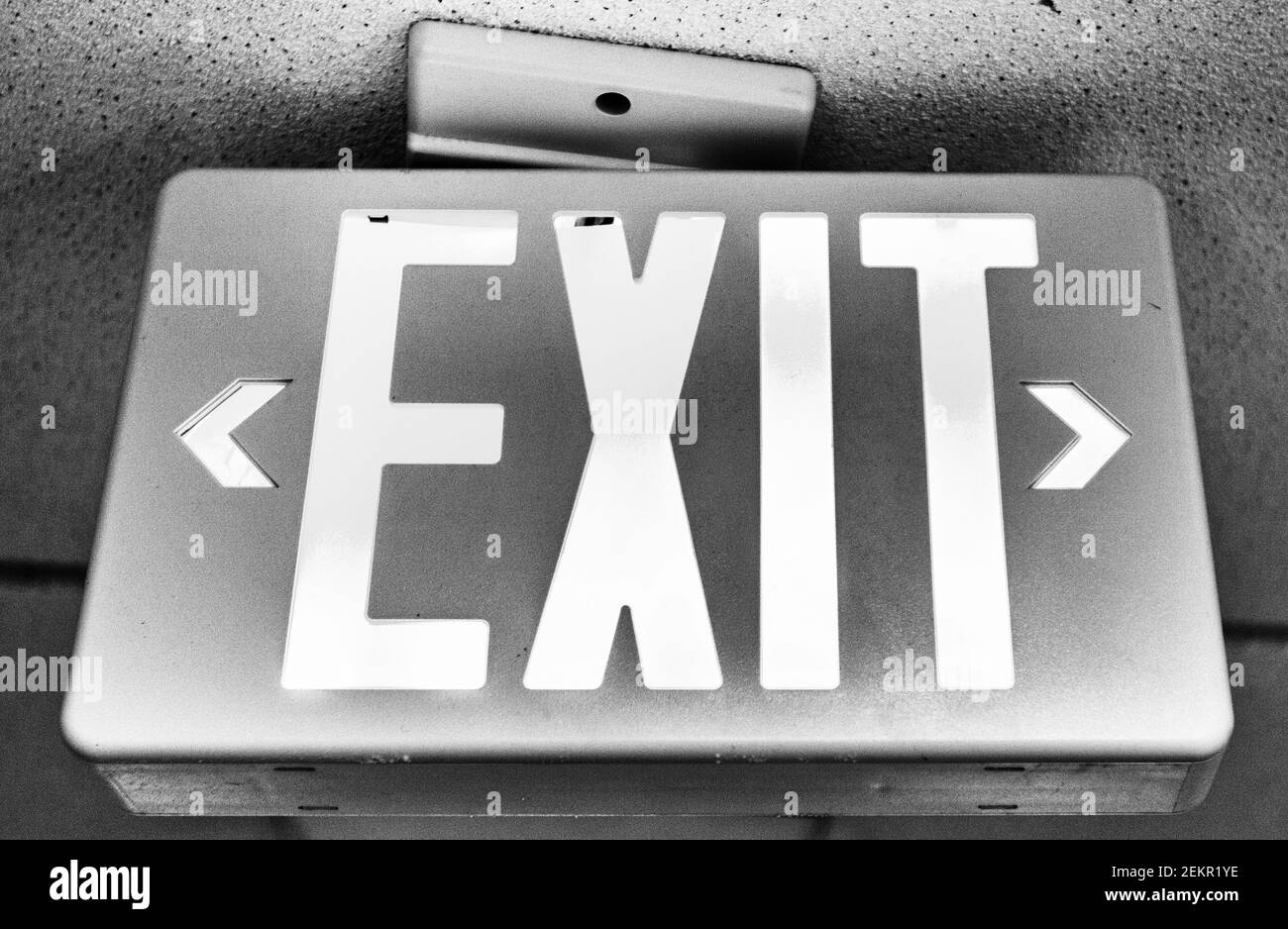 A sign on a ceiling says "EXIT." Stock Photo
