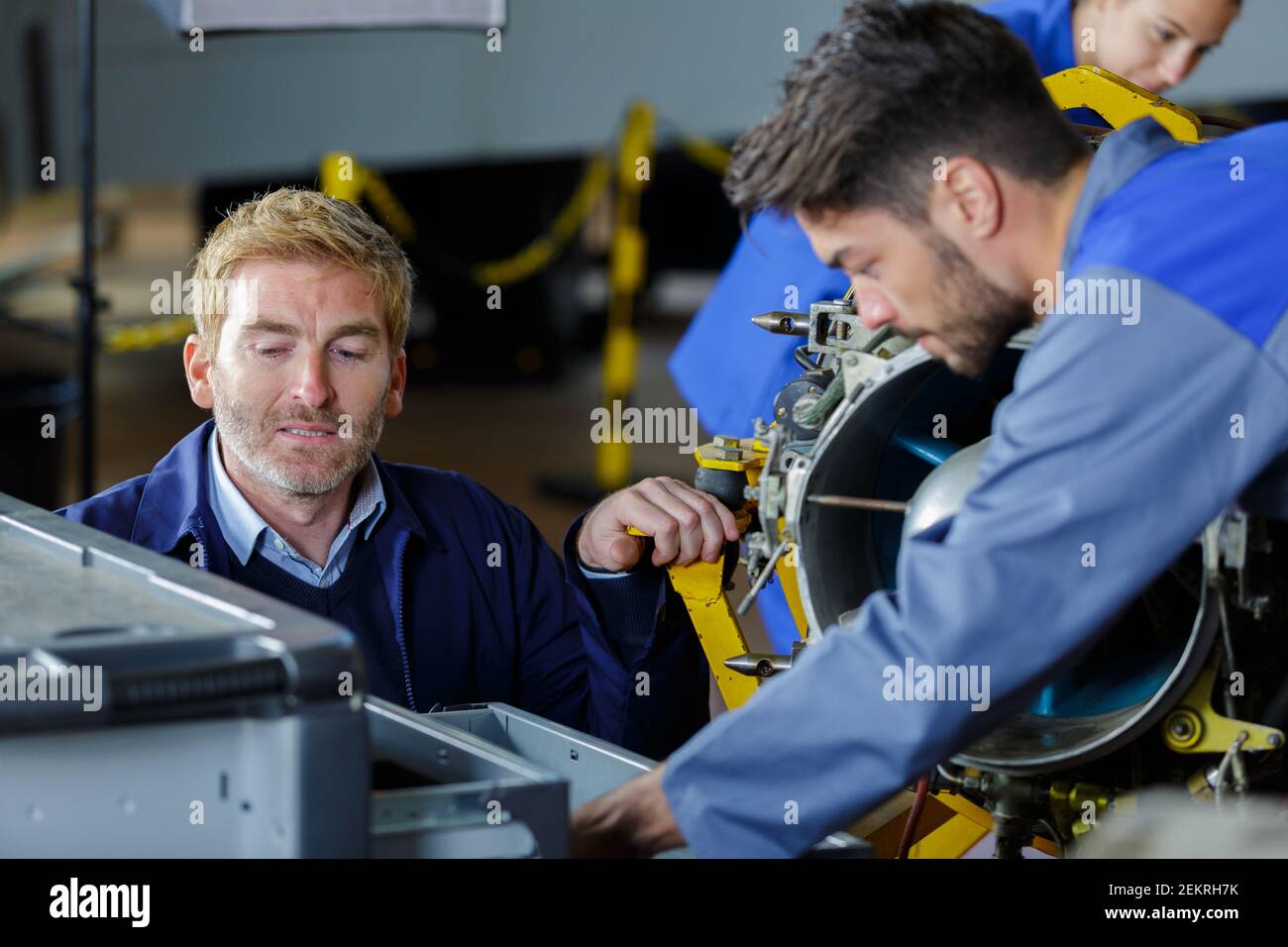 two engineers working in a machine Stock Photo - Alamy