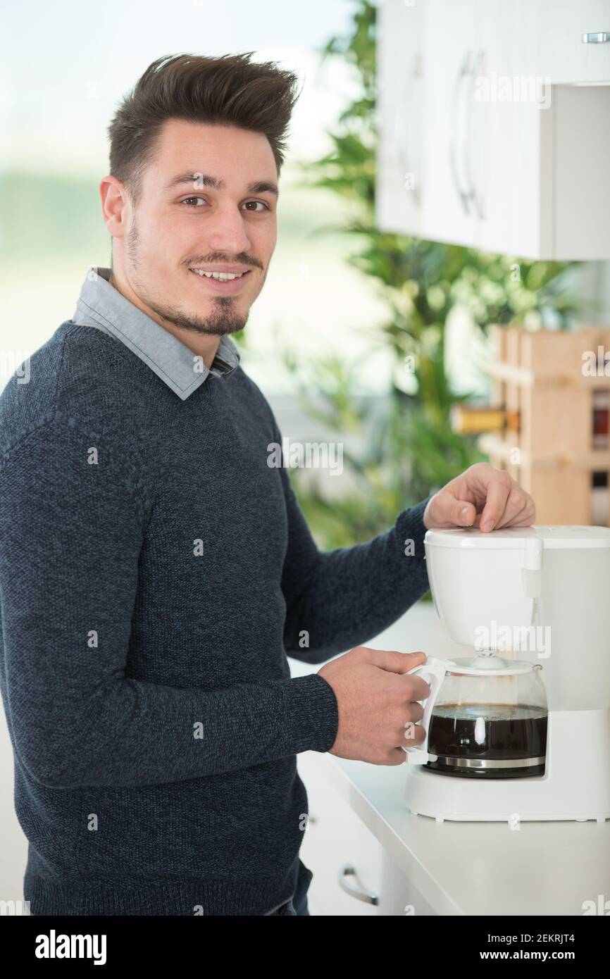 bearded man making morning espresso with coffee machine Stock Photo