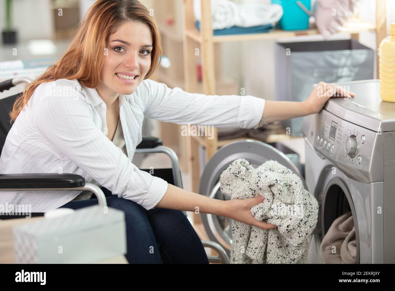 happy disable woman doing the laundry Stock Photo