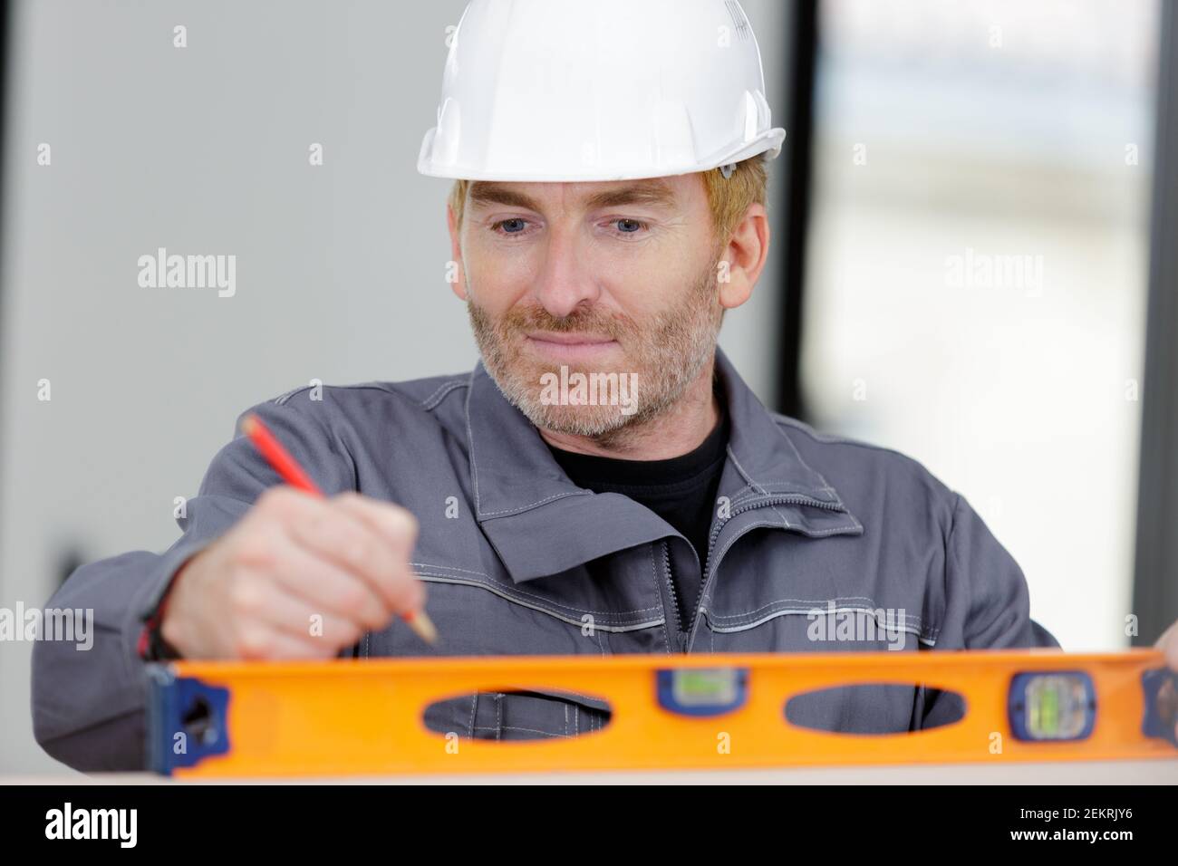 builder using bubble level at construction site Stock Photo Alamy