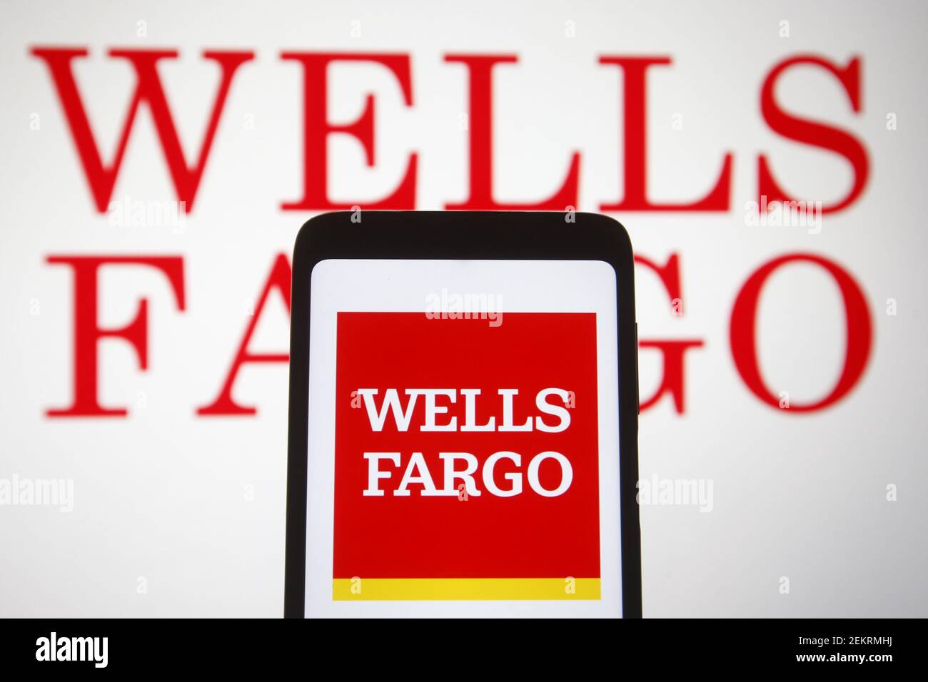 In this photo illustration, Wells Fargo logo of US financial services company is seen displayed on a smartphone and pc screen. Stock Photo