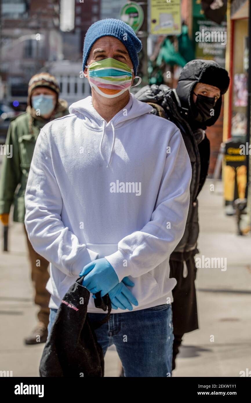 A man wearing gloves and a face mask as a precaution seen waiting in line to enter the store in Toronto's Kensington market due to COVID-19 Pandemic. (Photo by Shawn Goldberg / SOPA Images/Sipa USA) Stock Photo