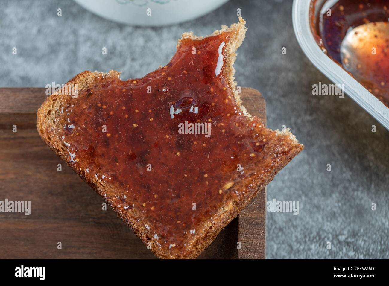 Bit slice of brown bread with strawberry jam Stock Photo