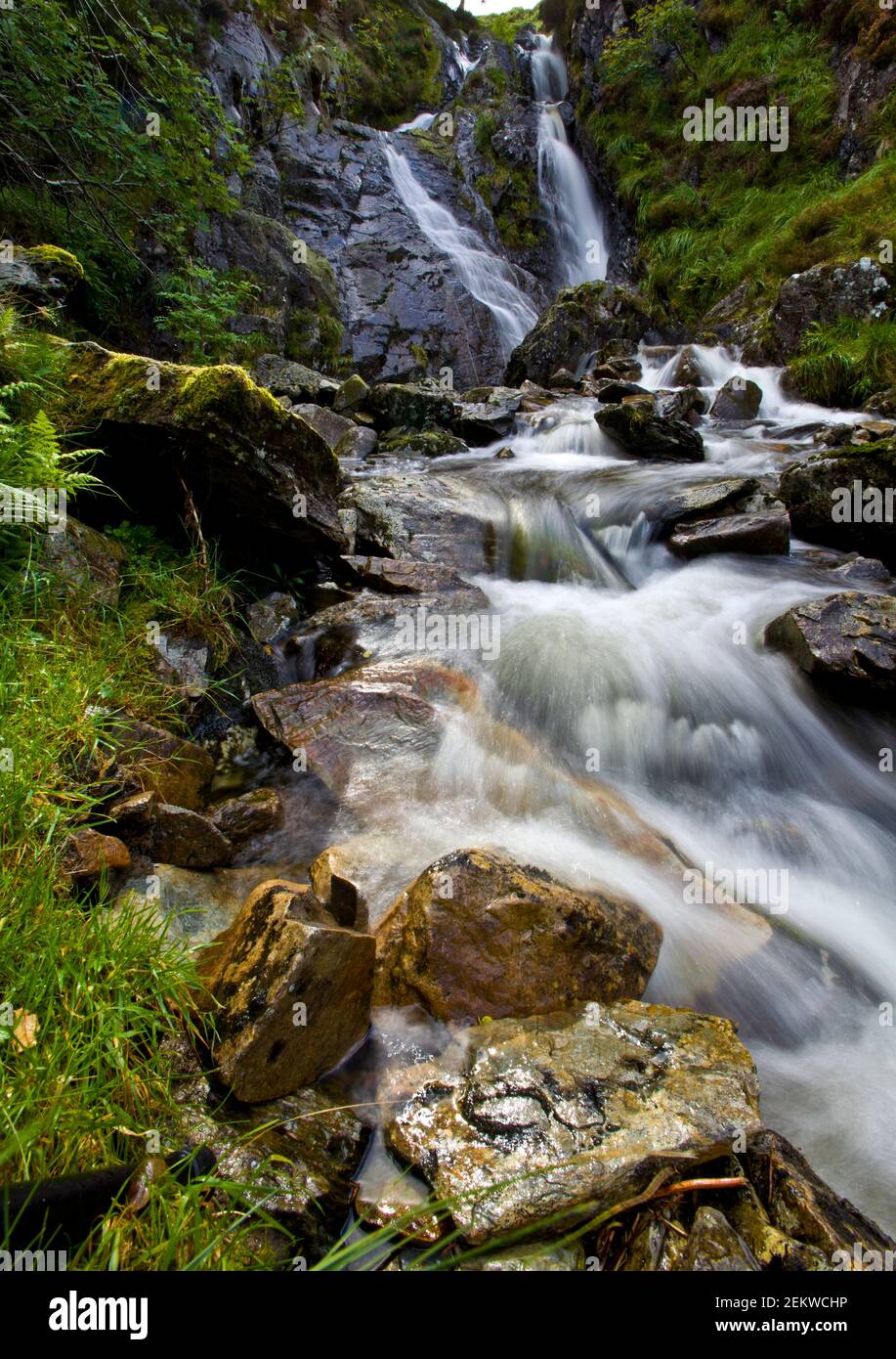 extended waterfall on a hillside, canyon, hiking, nature, running water, rocks, grasses, mountain walking, rural, outback Stock Photo
