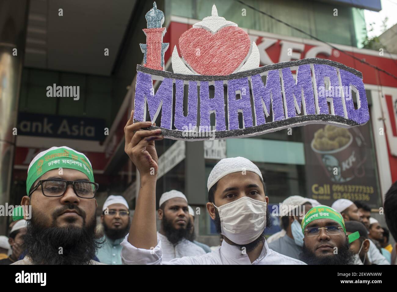 A Muslim protester displays a placard reading 'I love Muhammad' during ...