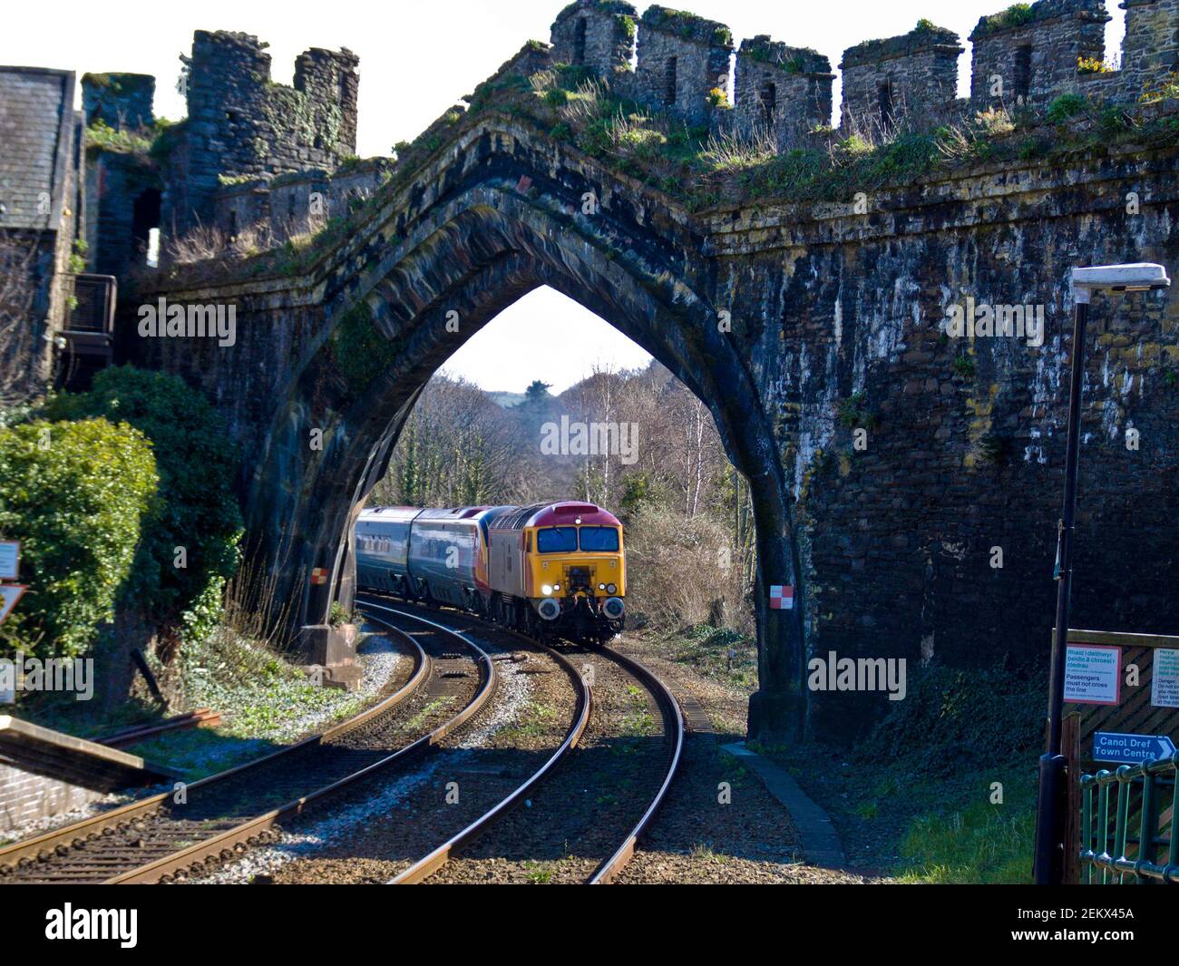 Virgin train, moving through an ancient, castle town, wall gate, arch, stone, Edward I, rural routes, holiday, travel, fast trains, scenic route Stock Photo