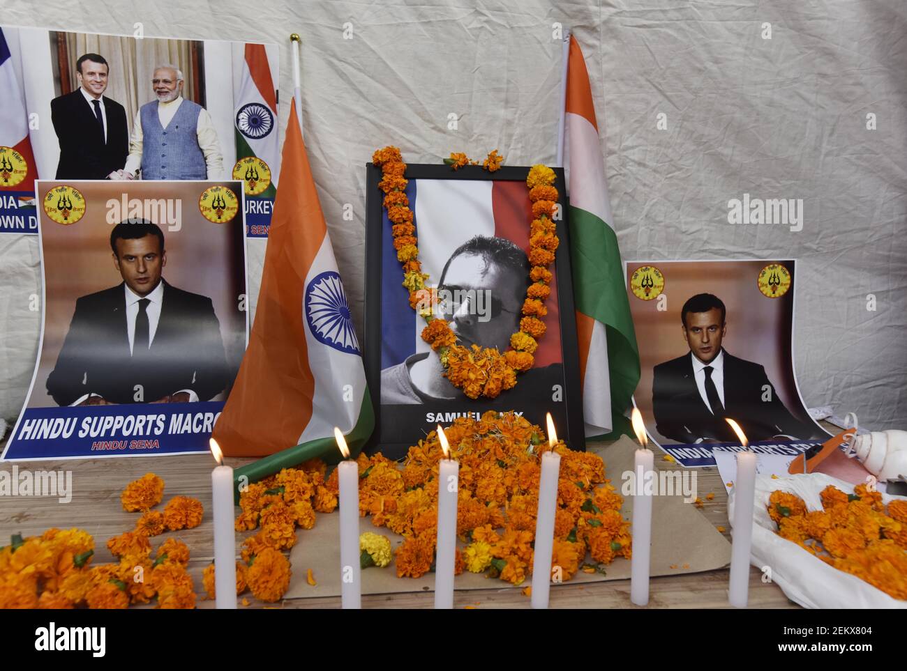 NEW DELHI, INDIA - OCTOBER 30: Photos of French President Emmanuel Macroon,  French teacher Samuel Paty who was beheaded for showing a cartoon of  Prophet Muhammad in his class, during a condolence