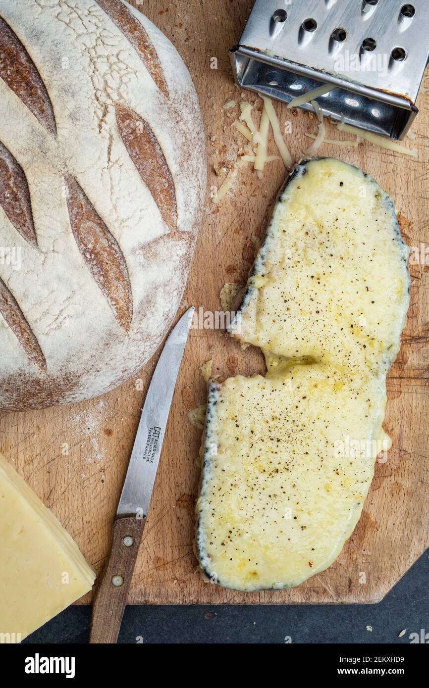 Cheese on toast. Cheese on toasted Sourdough bread on a wooden chopping board Stock Photo