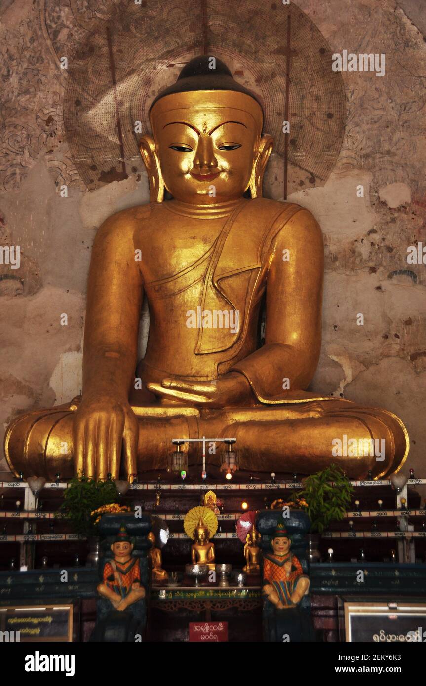 Golden buddha image statue burma style in Ananda paya temple for burmese and foreign traveler travel visit respect praying in Minnanthu village at Bag Stock Photo