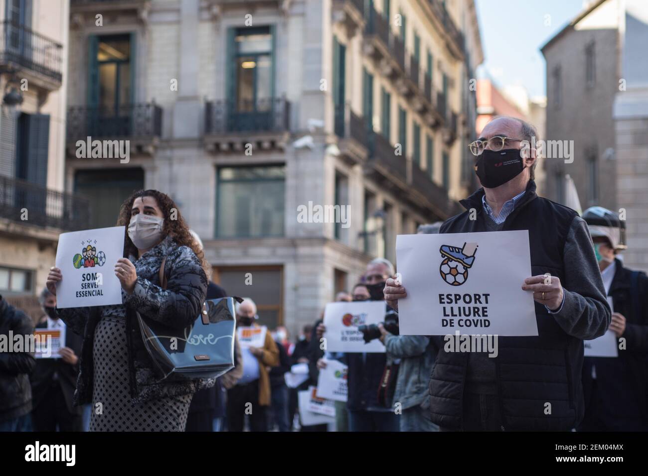 Protesters wearing face masks hold placards during the demonstration. Catalan sports federations and entities have demonstrated in Barcelona to demand the reopening of gyms and sports facilities in Catalonia. (Photo by Thiago PrudÃªncio / SOPA Images/Sipa USA)  Stock Photo