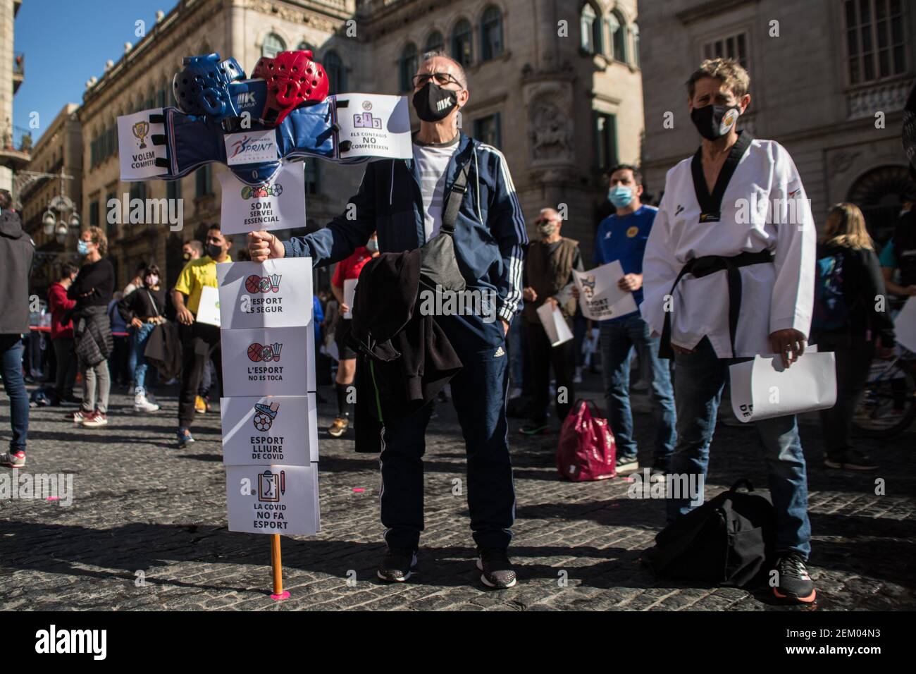 Protesters wearing face masks hold placards during the demonstration. Catalan sports federations and entities have demonstrated in Barcelona to demand the reopening of gyms and sports facilities in Catalonia. (Photo by Thiago PrudÃªncio / SOPA Images/Sipa USA)  Stock Photo