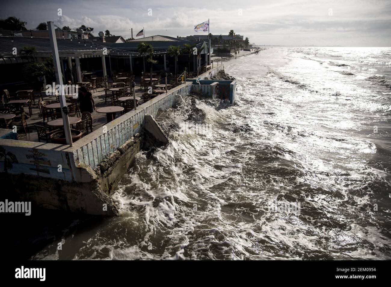 Nov 12, 2020; Fort Myers Beach, FL, USA; An employee of the Pierside Grill  and Famous Blowfish Bar Fort Myers Beach cleans up on Thursday, November  12, 2020 after Hurricane Eta swiped