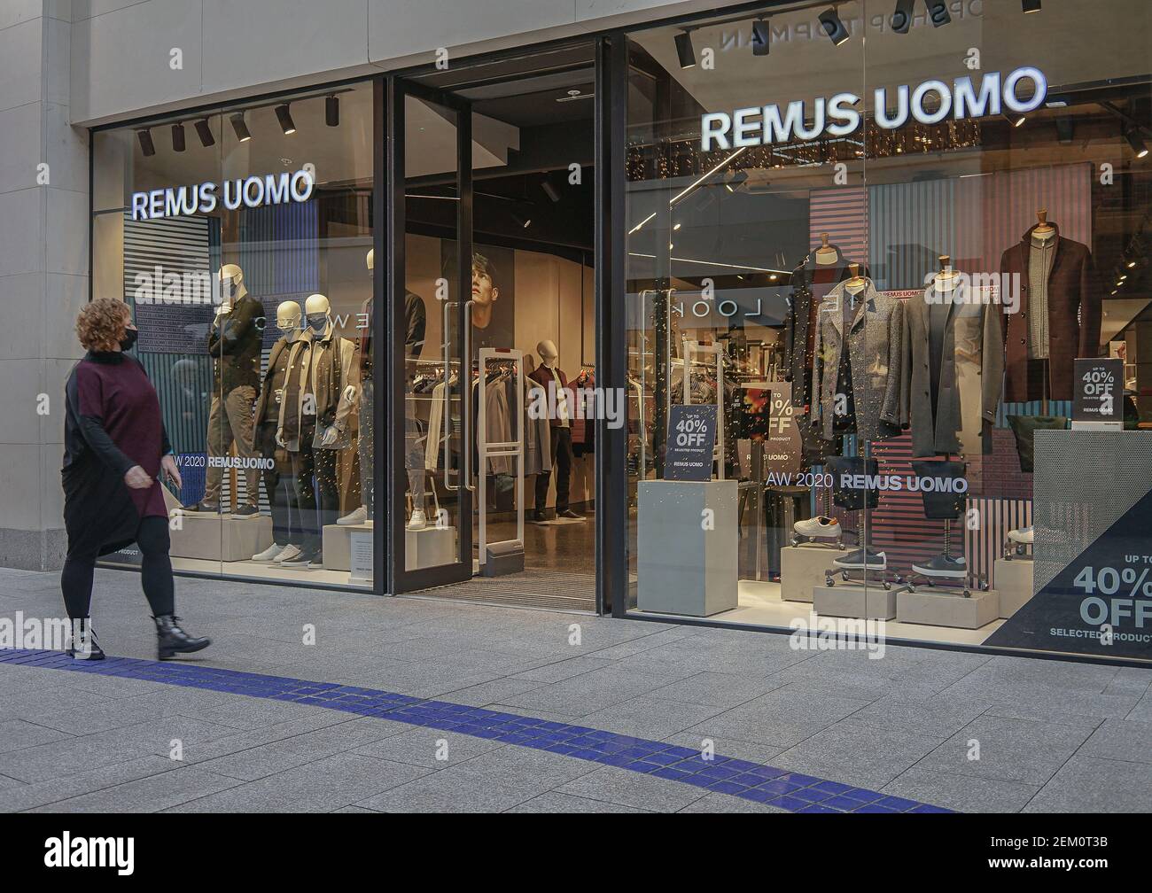 A woman wearing a face mask walks past a Remus Uomo Store. (Photo by  Michael McNerney / SOPA Images/Sipa USA Stock Photo - Alamy