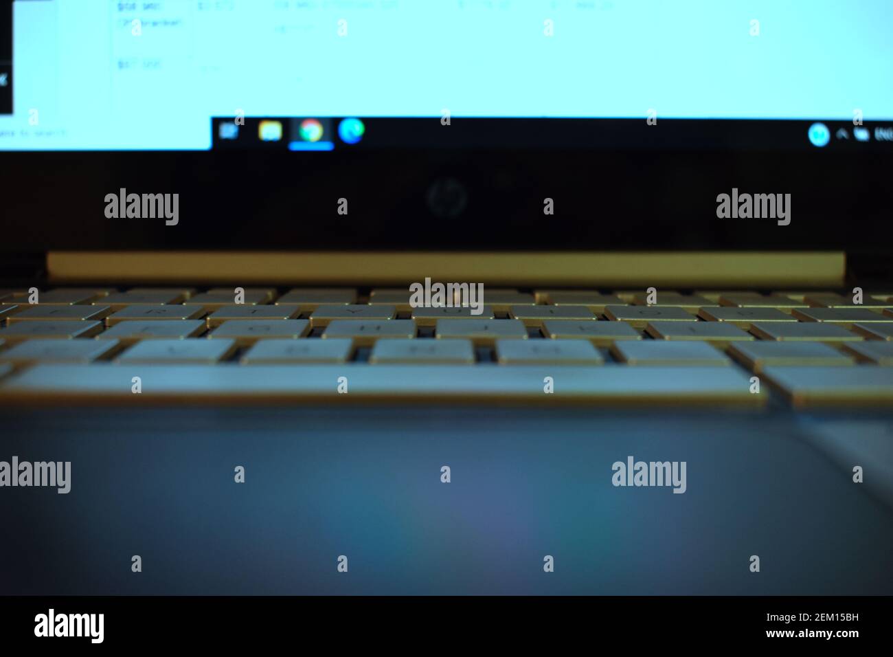 the keyboard on a HP (Hewlett-Packard) - Pavillion laptop with the blue light from the screen shining onto the keyboard Stock Photo