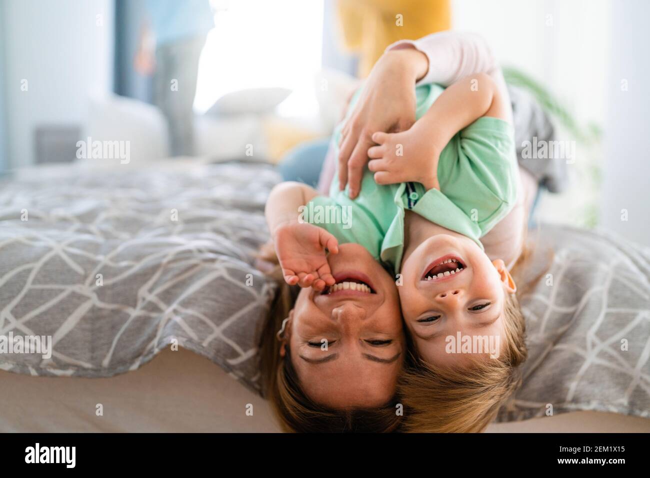 Happy little toddler boy having fun with his mother at home. Single parenting, happiness concept. Stock Photo