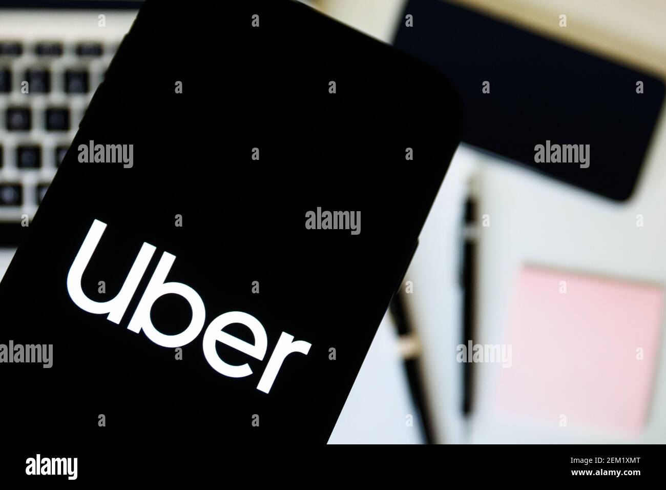 In this photo illustration a Uber company logo seen displayed on a ...