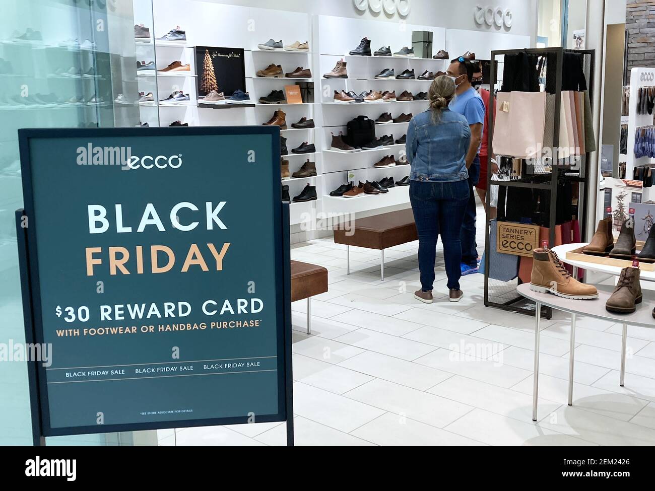 Shoppers are seen a store with a Black Friday sale sign at The Mall at Millenia as prepare for one the busiest shopping days of the year. Many