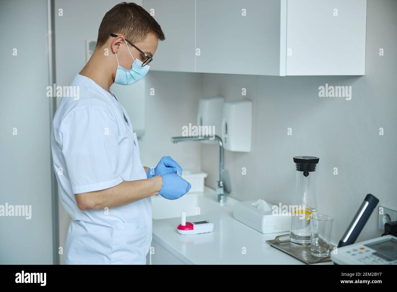 Focused doctor getting ready for performing a spirometry test Stock