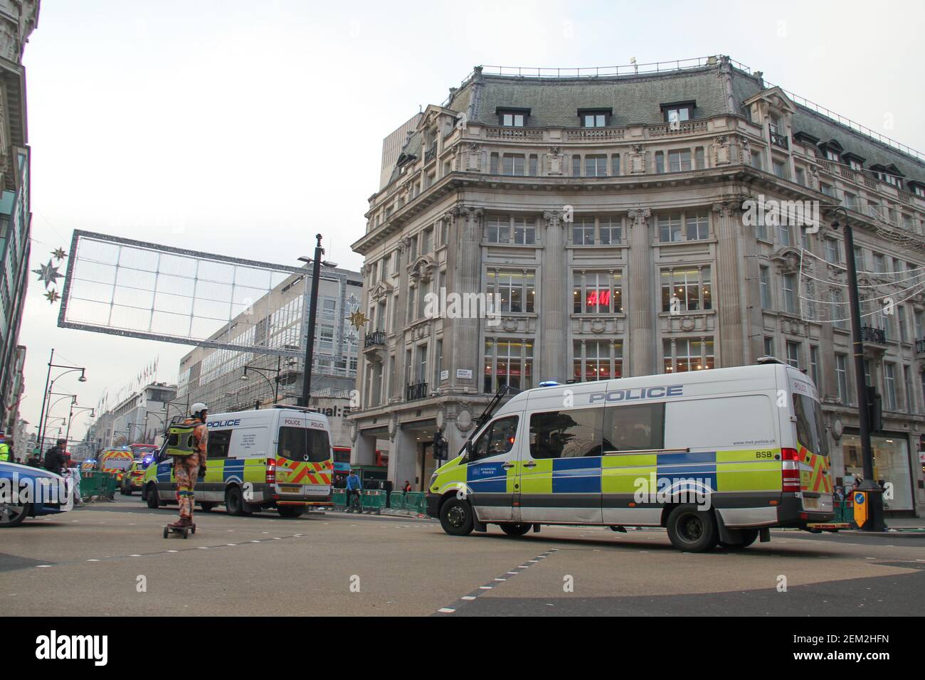 Police vans race through Oxford Circus towards Marble Arch during the  demonstration. Starting at Marble Arch, anti-Lockdown protesters moved  towards Piccadilly Circus where groups of fully kitted police officers were  positioned and
