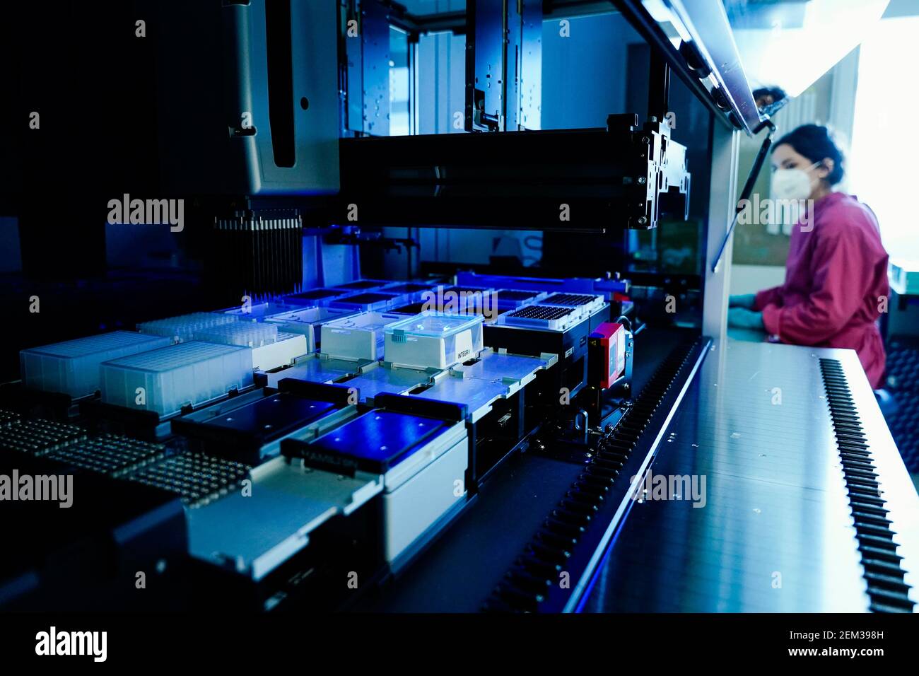 Heidelberg, Germany. 23rd Feb, 2021. A member of staff sits behind a