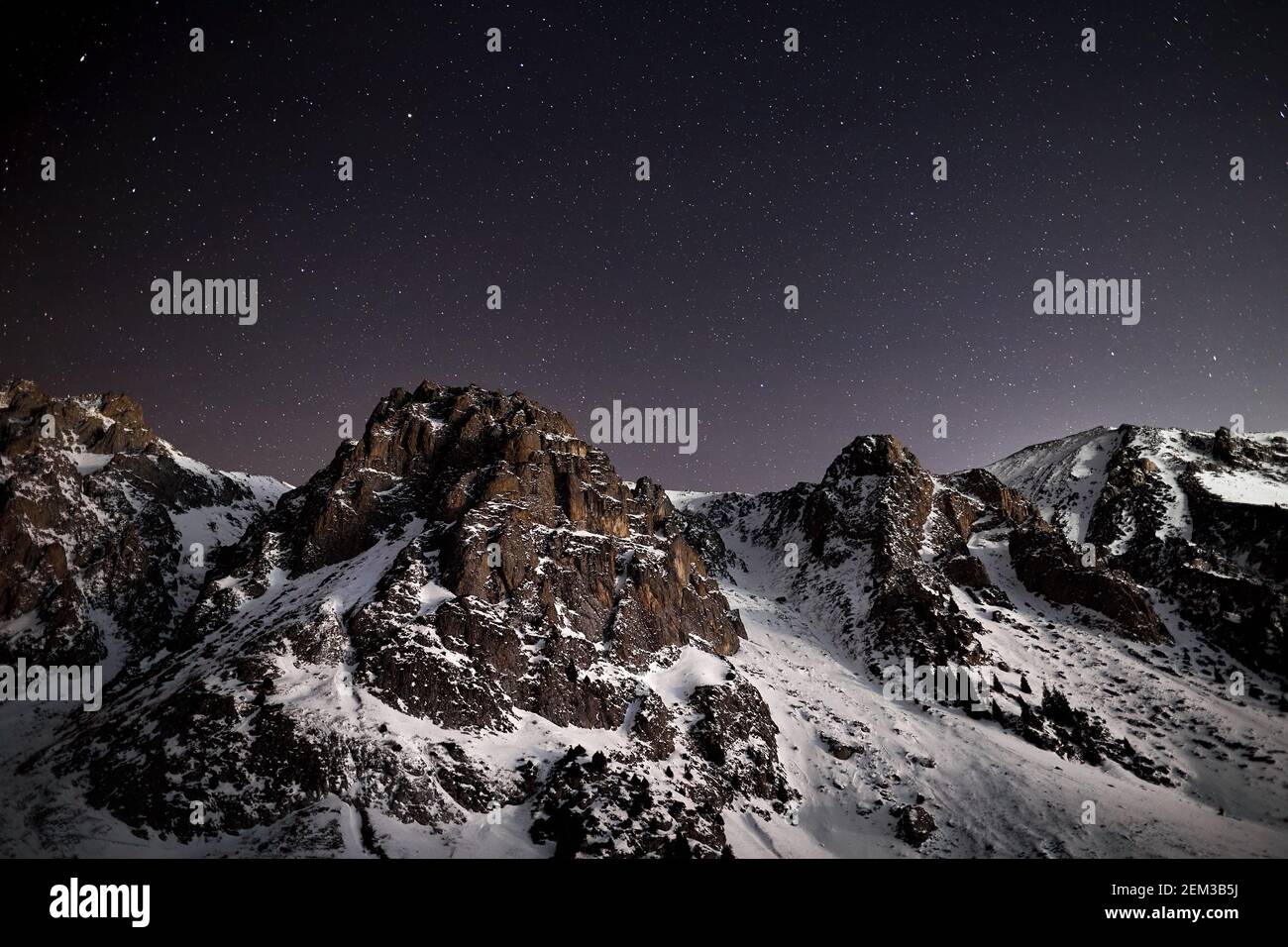 Dramatic landscape of mountain range at night sky with stars near Almaty, Kazakhstan Stock Photo
