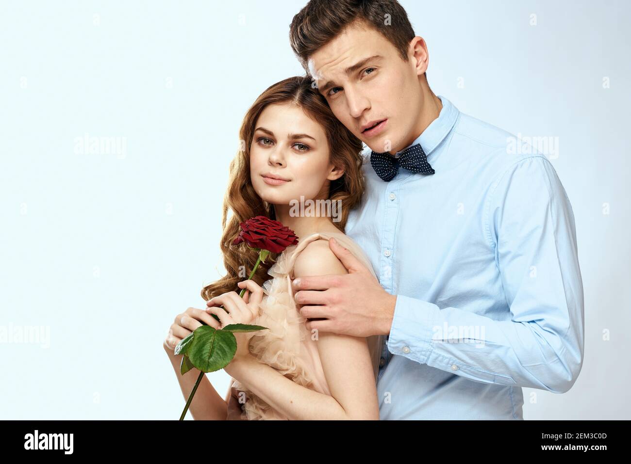 Cute young couple hug rose date luxury charm Stock Photo - Alamy