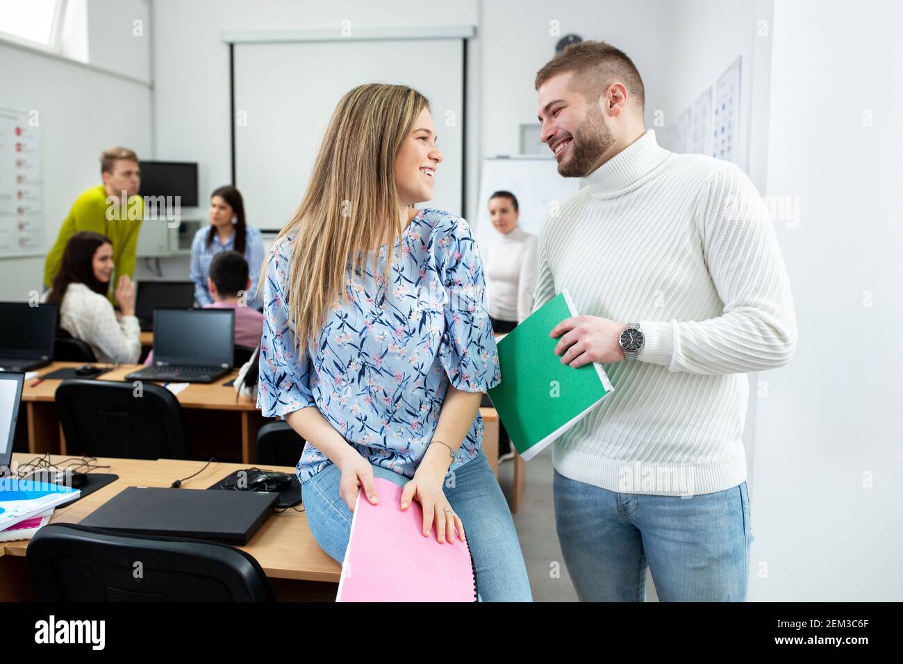 Guy and a girl flirting in the classroom, student concept Stock Photo ...