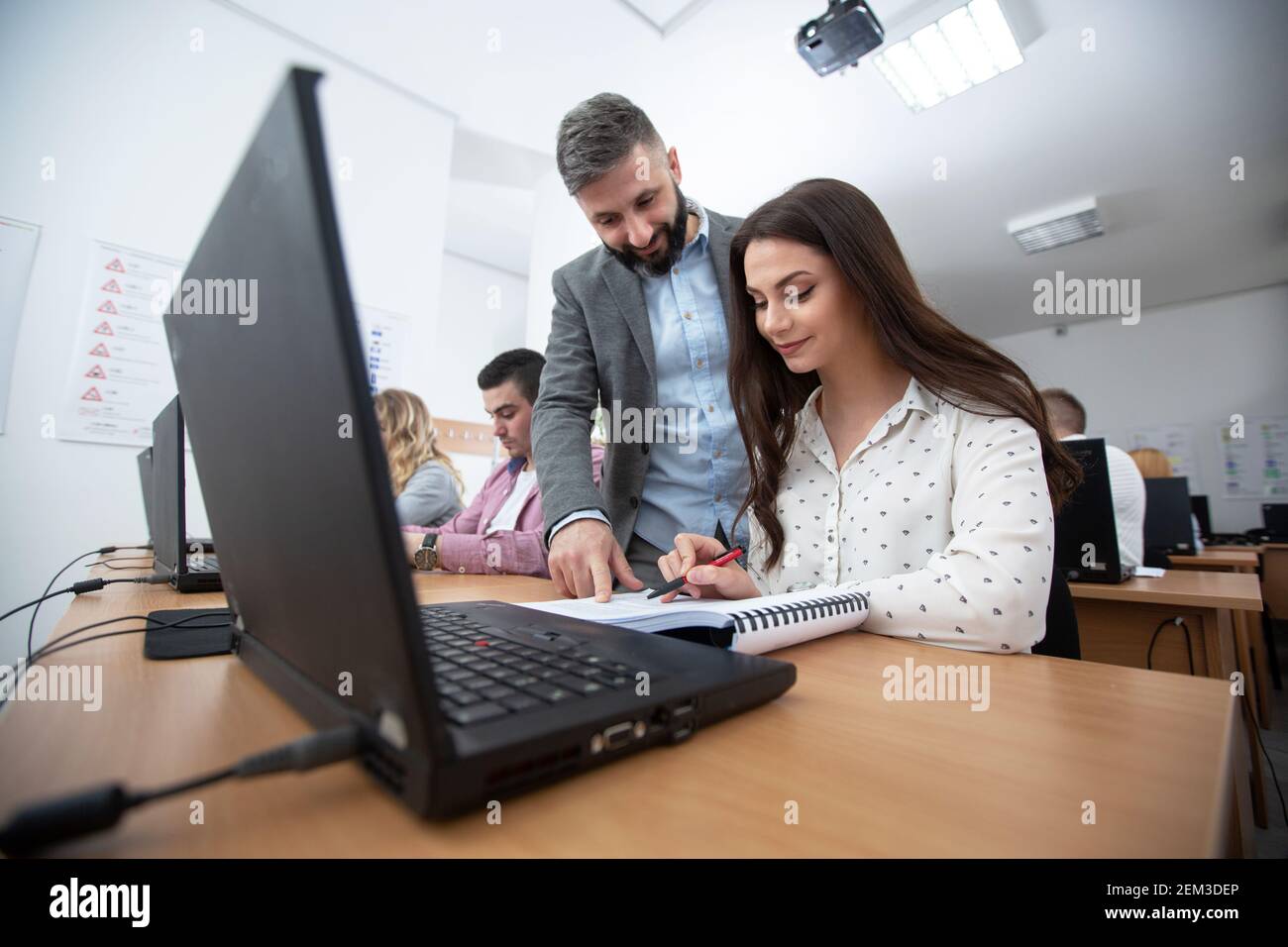 Students in drivers school learning traffic rules from their instructor