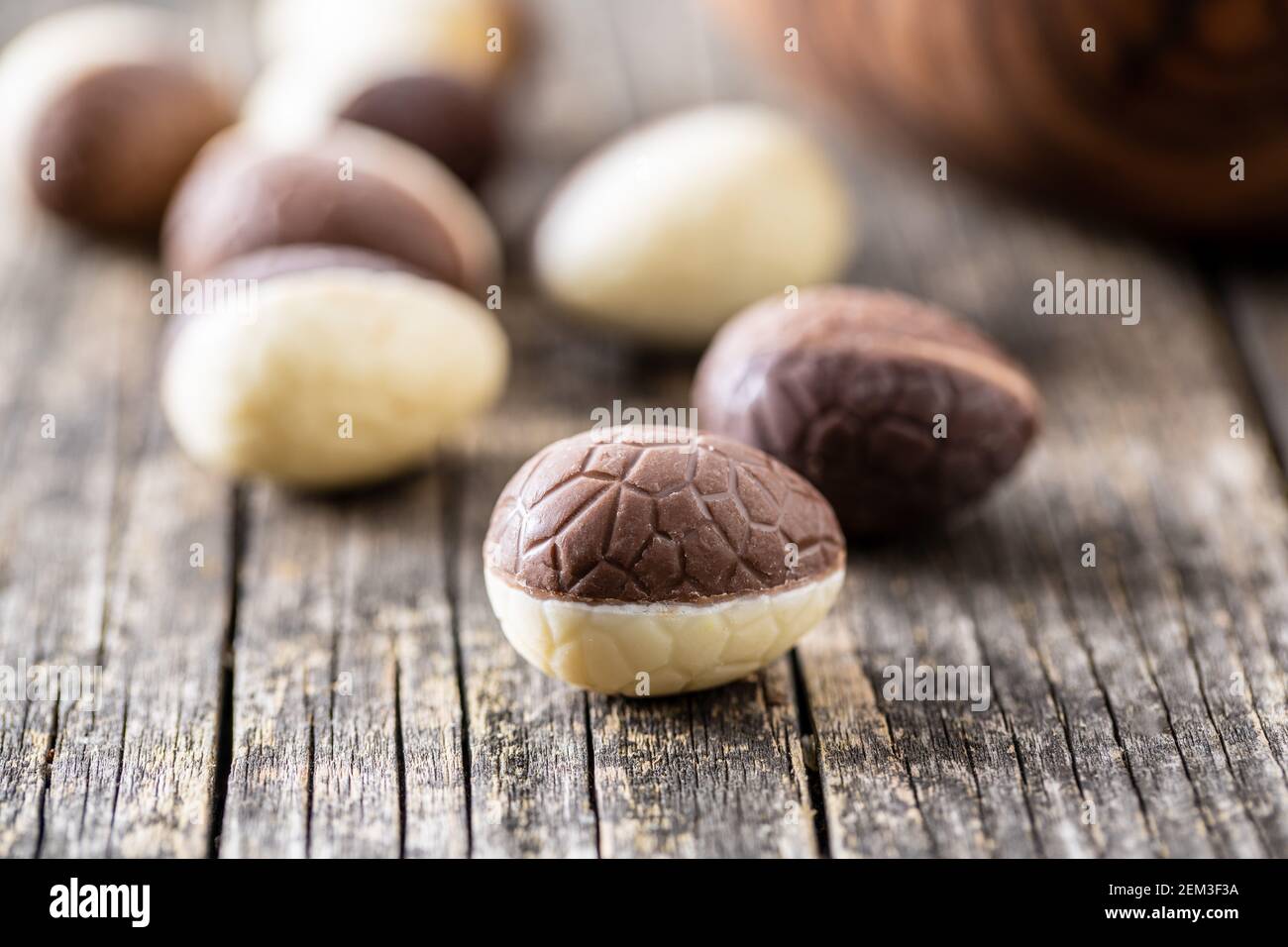 Chocolate easter eggs. Sweet candy eggs on a wooden table. Stock Photo