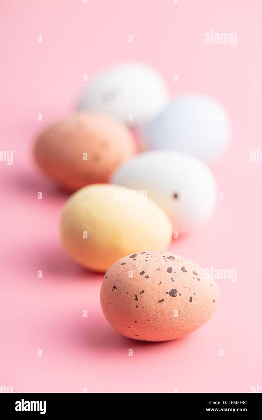 Colorful chocolate easter eggs. Sweet candy eggs on a pink background. Stock Photo