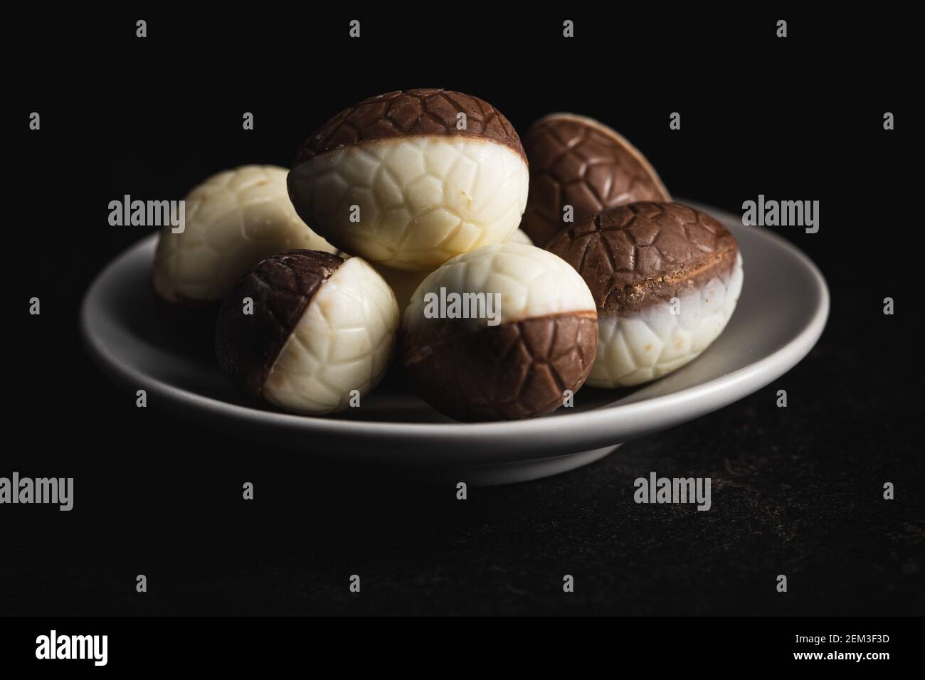 Chocolate easter eggs. Sweet candy eggs on a plate. Stock Photo