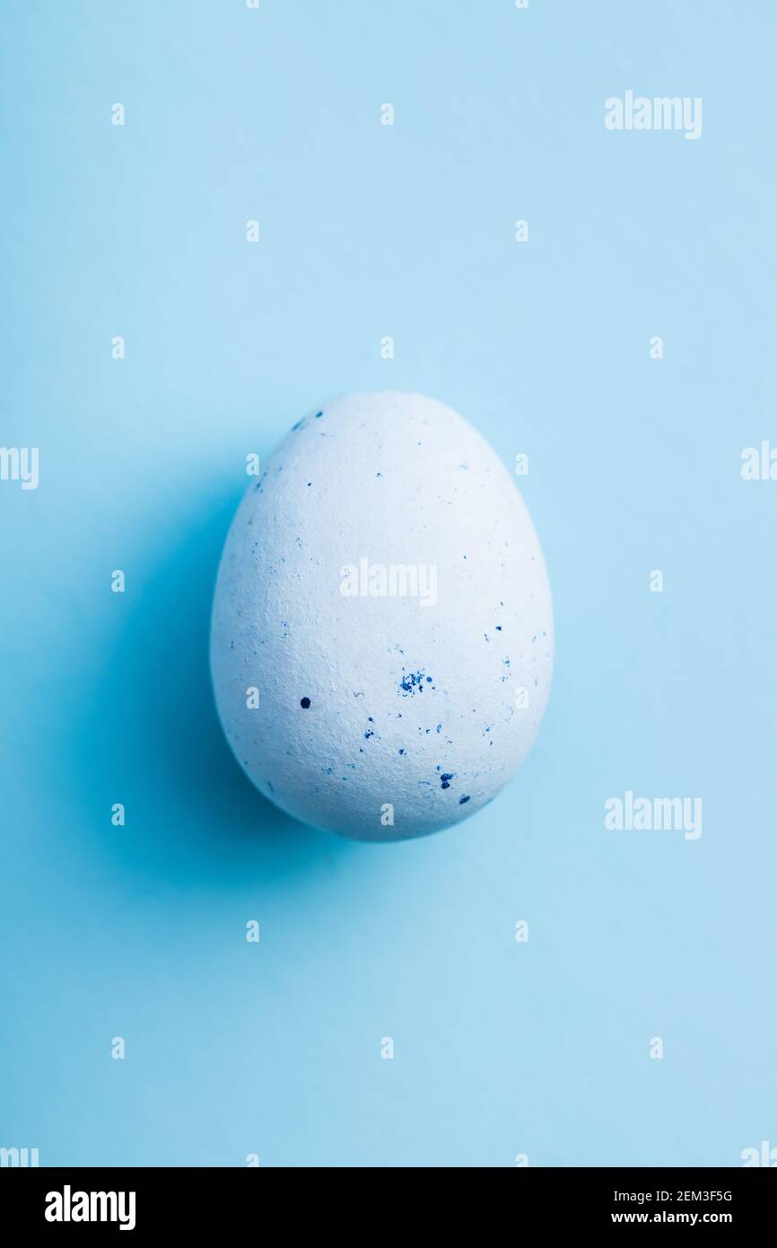 Blue chocolate easter egg. Sweet candy egg on a blue background. Top view. Stock Photo